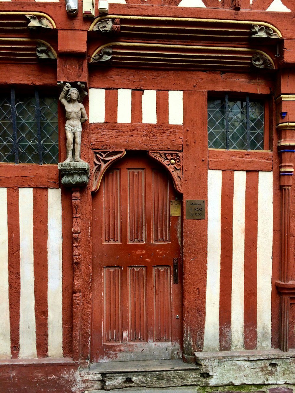 white and brown building with arch door