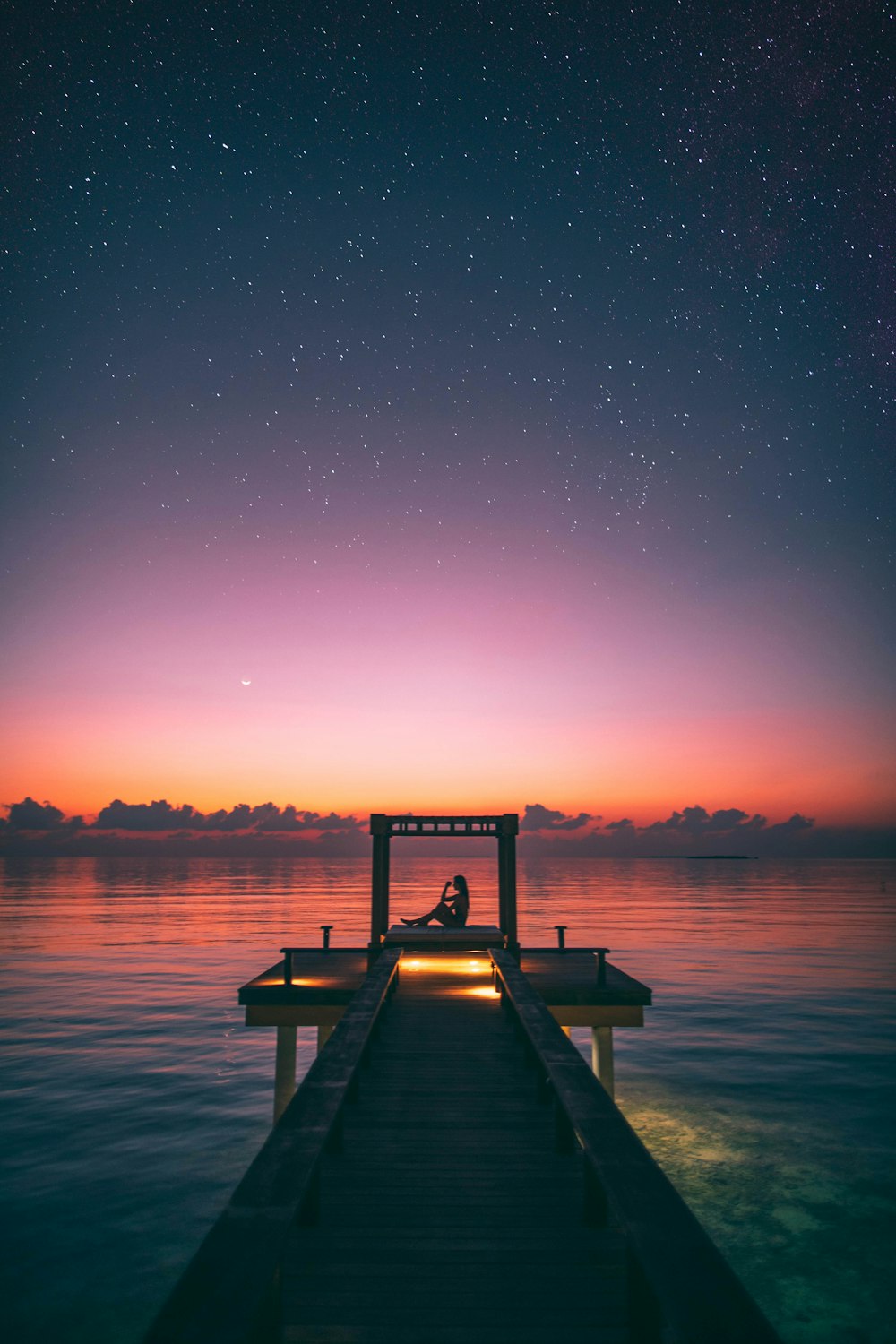 people on dock during golden hour