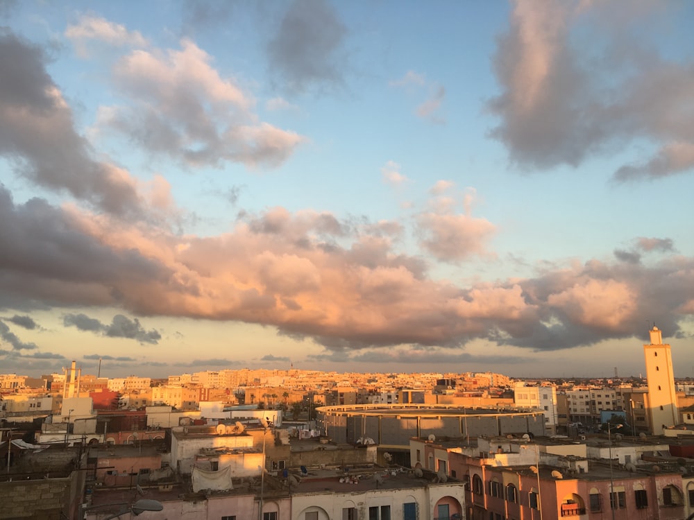 city with high-rise buildings under orange and blue skies