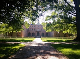 castle in front of trees during daytime