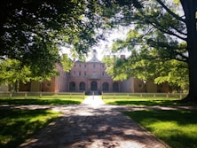 castle in front of trees during daytime