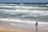 man in green walking on a beach