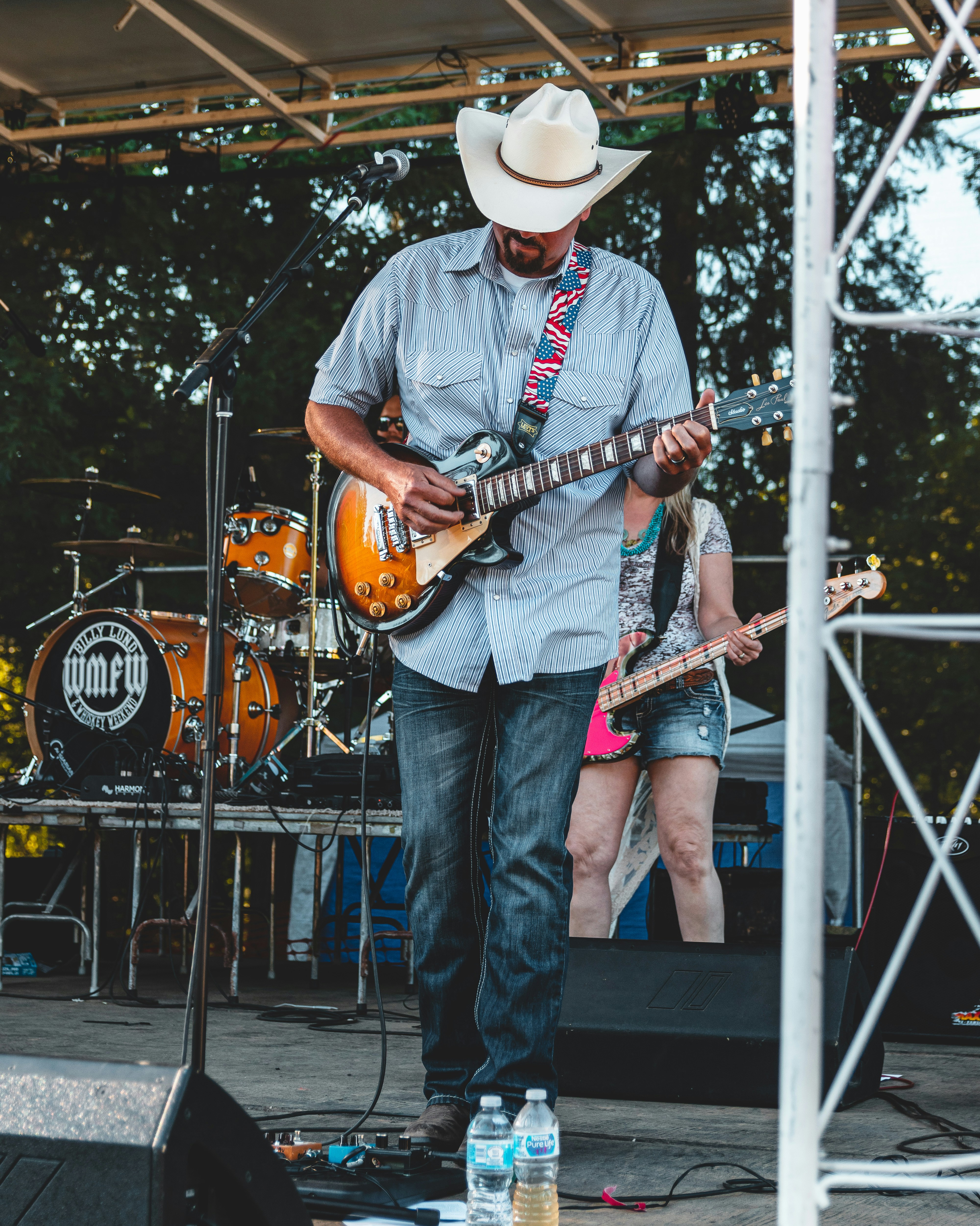 Hombre de pie en el escenario tocando la guitarra