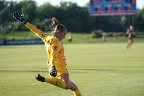 Close-up of a referee showing a yellow card during a soccer match.