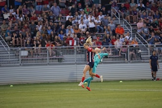 A vibrant indoor soccer match in action, showcasing players in dynamic poses on the field.