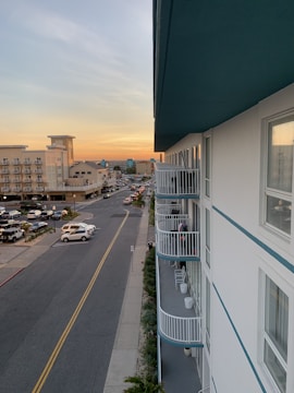 Front view of a modern duplex villa with balconies and garage at sunset
