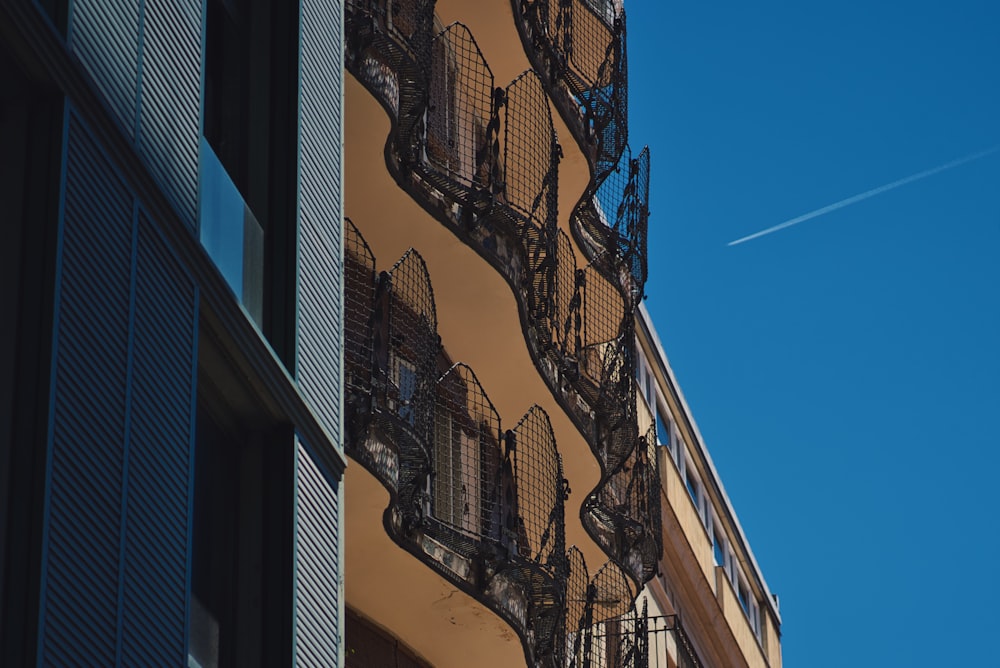 low-angle photography of multi-storey building under calm blue sky