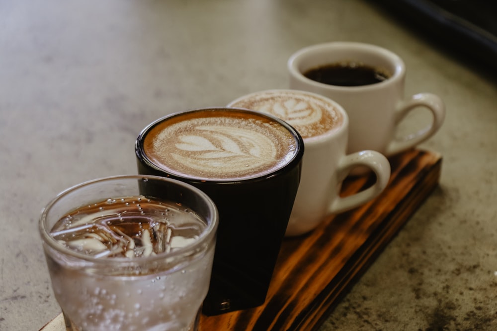 four mugs filled with coffee