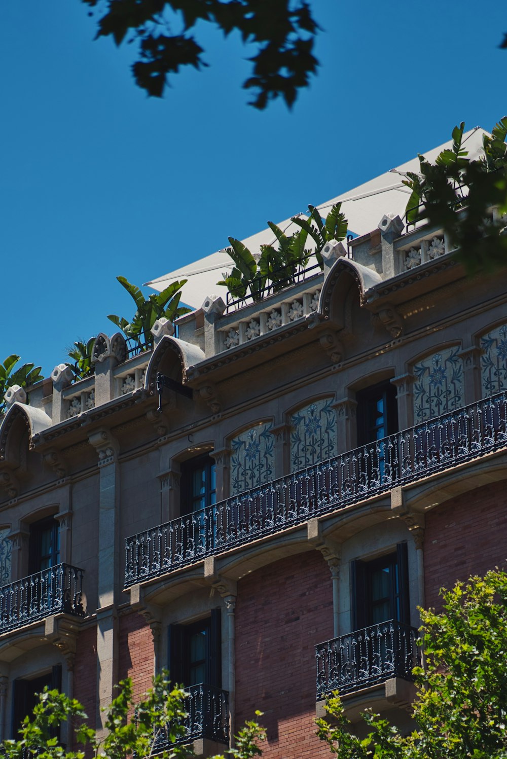 brick house with balcony and plants