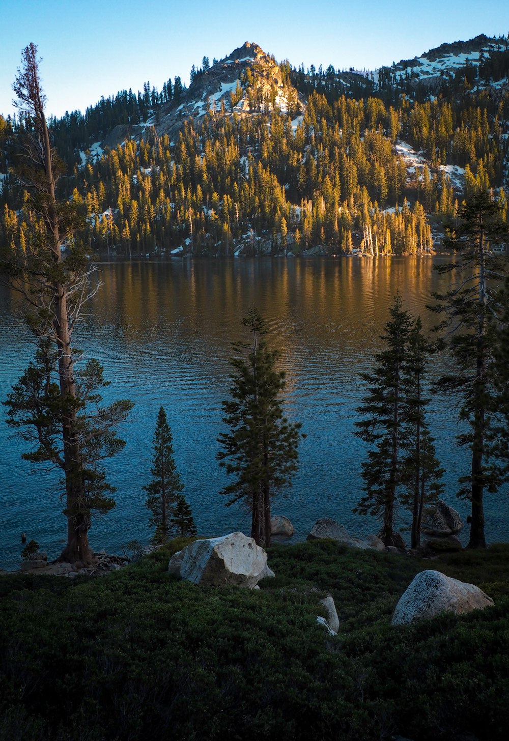 mountain covered with snow near lake