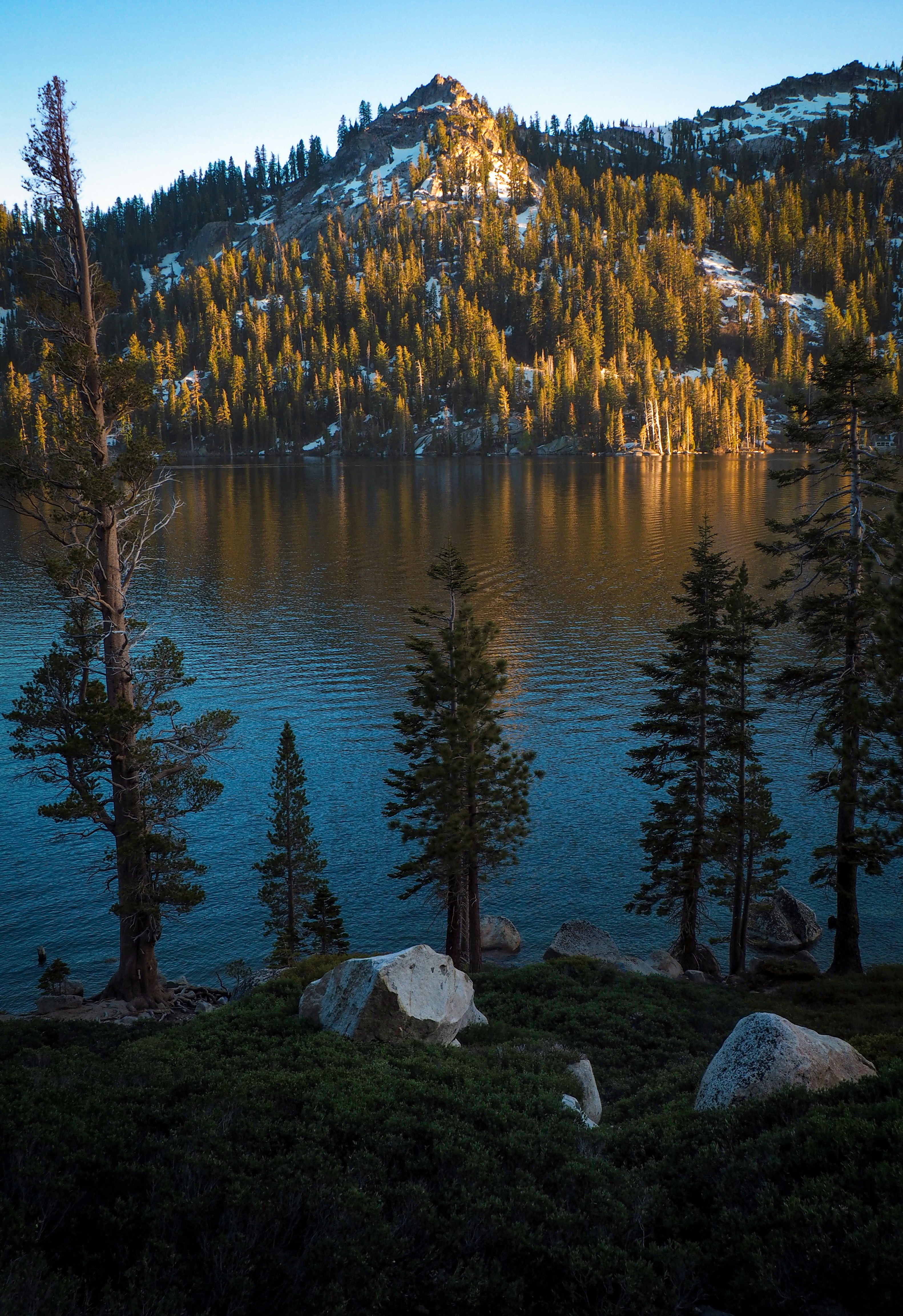 mountain covered with snow near lake