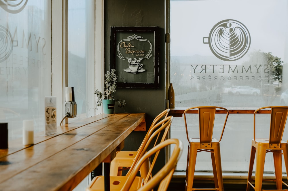 empty wooden long table and chairs inside room