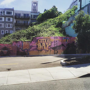 Colorful street art mural in a lively California city neighborhood
