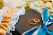 gold-colored wedding rings on Bible scripture