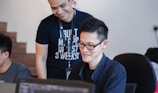 man standing behind sitting man
