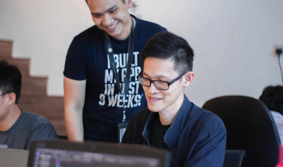 A mentor guiding a student through their code one-on-one