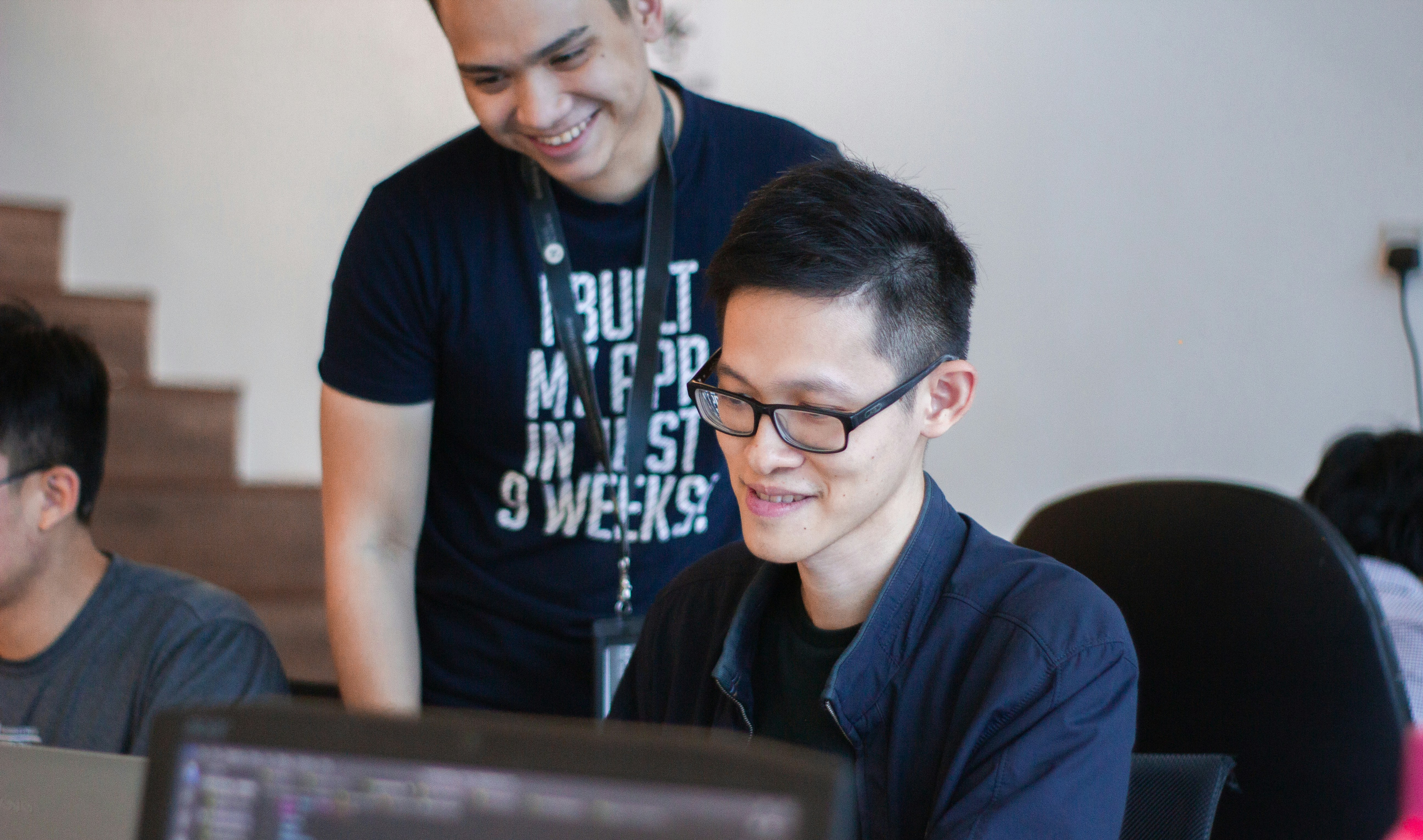 A mentor guiding a coding student 
