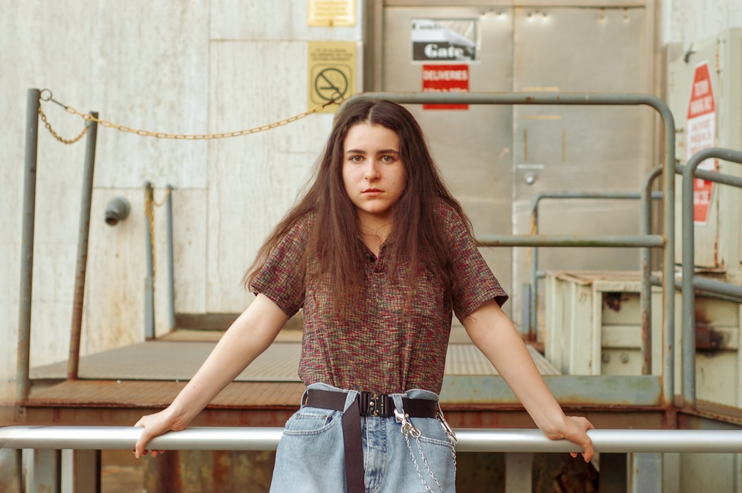 woman in brown button-up shirt and blue jeans