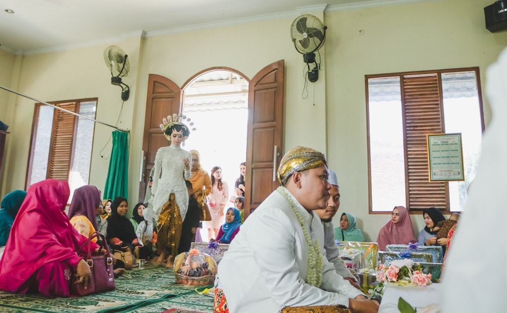 people wearing hijab sitting on floor