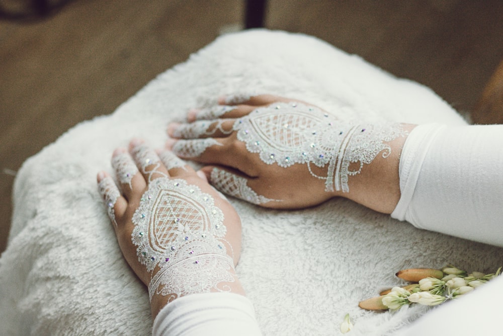 person with white lace hand gloves