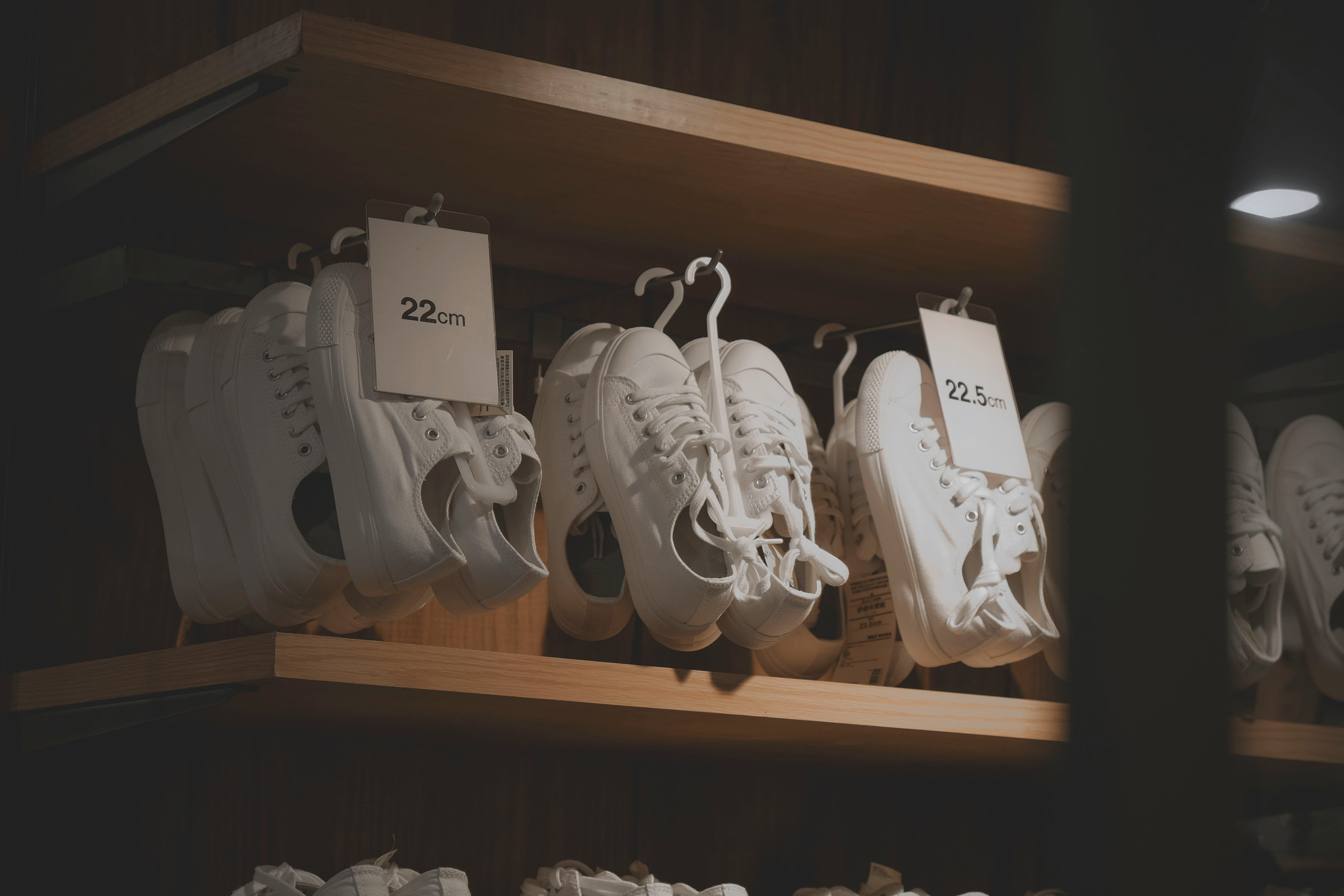 pile of white sneakers with price tags