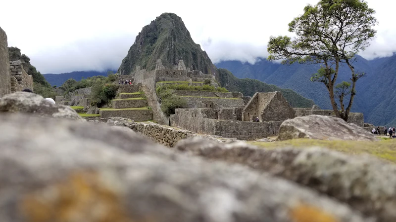 Machu Picchu below Huayna Picchu, with the Sacred Valley peaks beyond