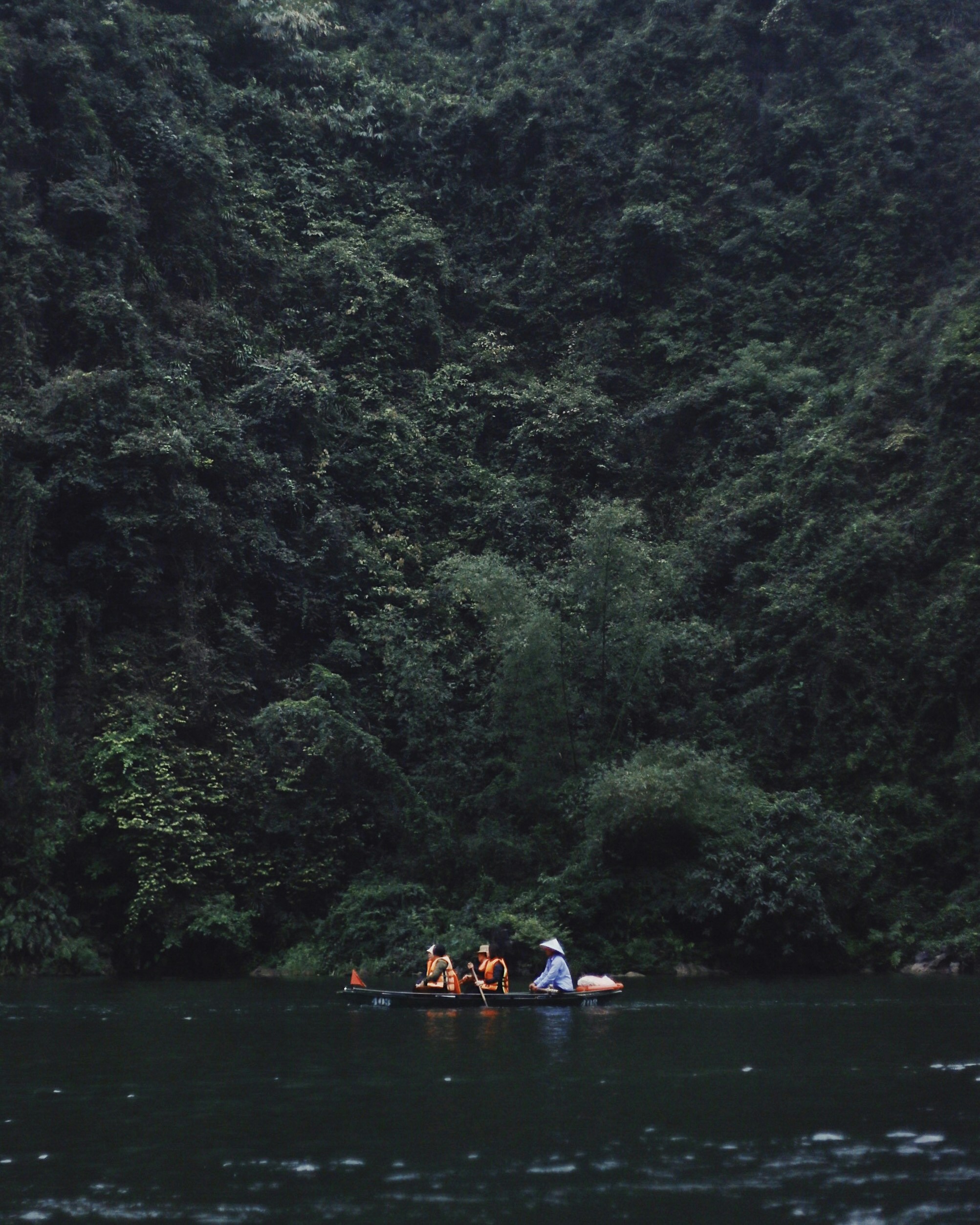 men riding a boat in body of water