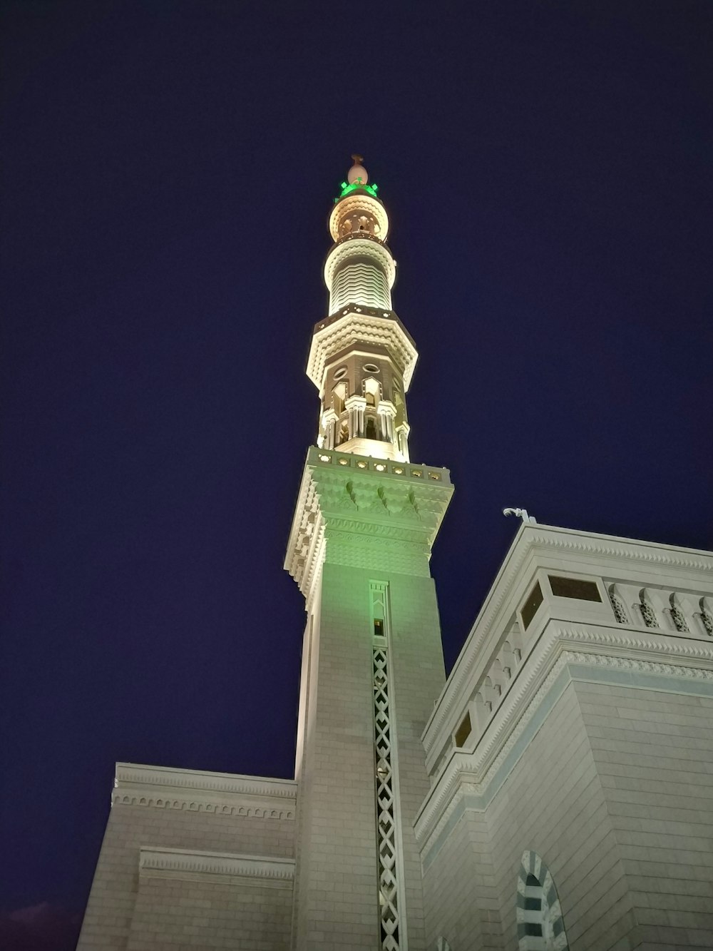 low-angle photography of gray concrete tower during night