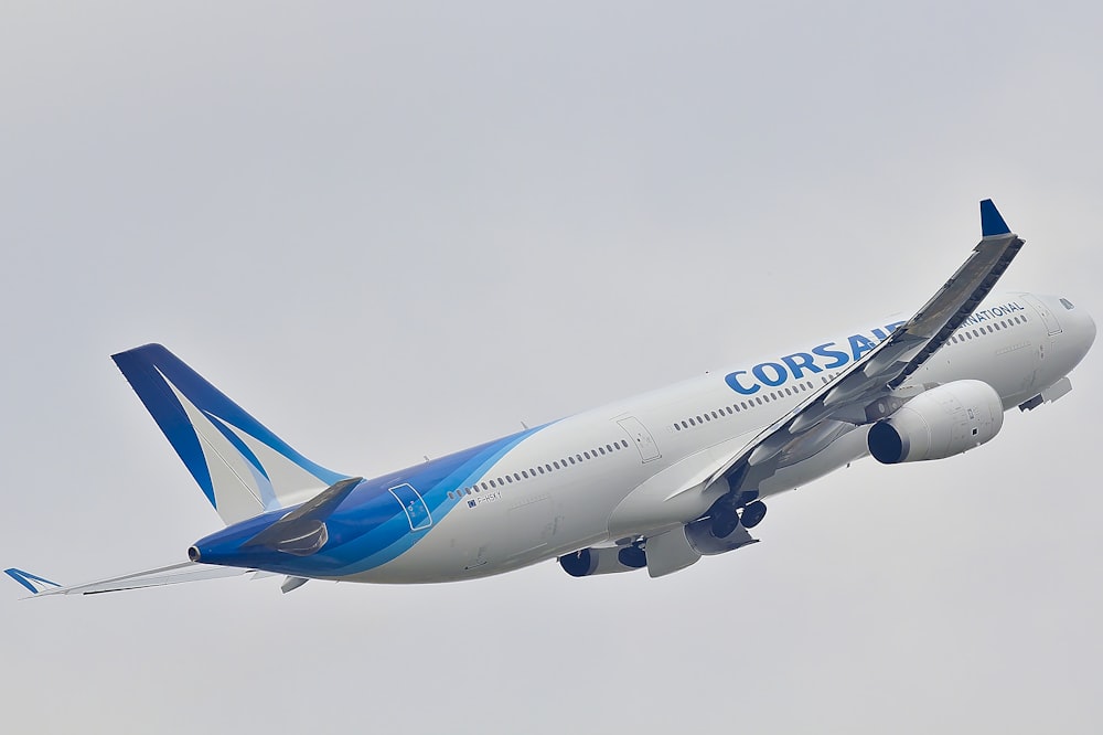 selective focus photography of white and blue Corsair airplane