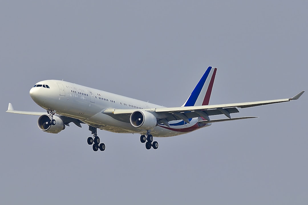 blue, red, and white airplane in flight,