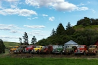 A lineup of various used VL horse trucks displayed outdoors.