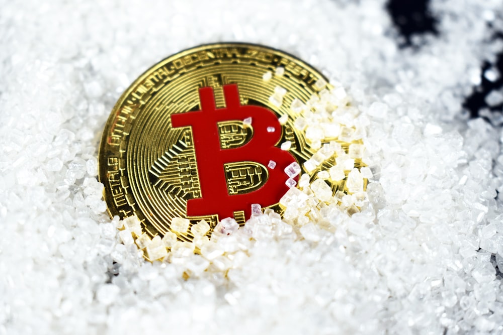 gold-colored and red Bitcoin