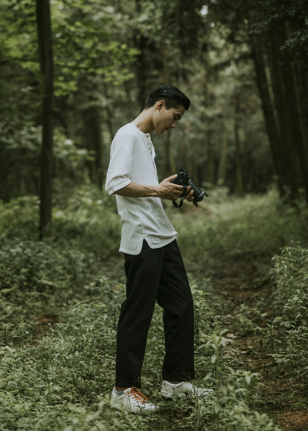 man standing black DSLR camera