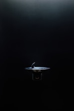 Close-up of a smart pet water fountain glowing softly with mint green accents, reflecting modern tech-minimalism design.