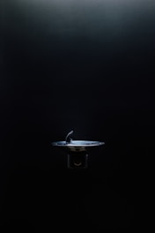 Modern water filtration fountain installed in a bright office kitchen.