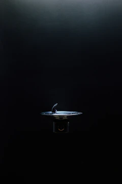 A sleek smart water refill station installed in a bright university hallway with students using it.