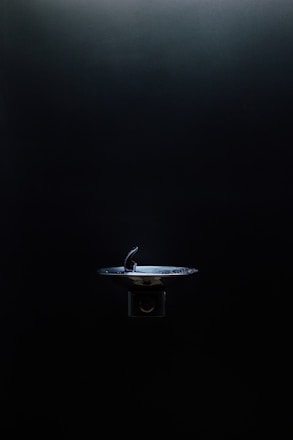 Modern water filtration fountain installed in a bright office kitchen.