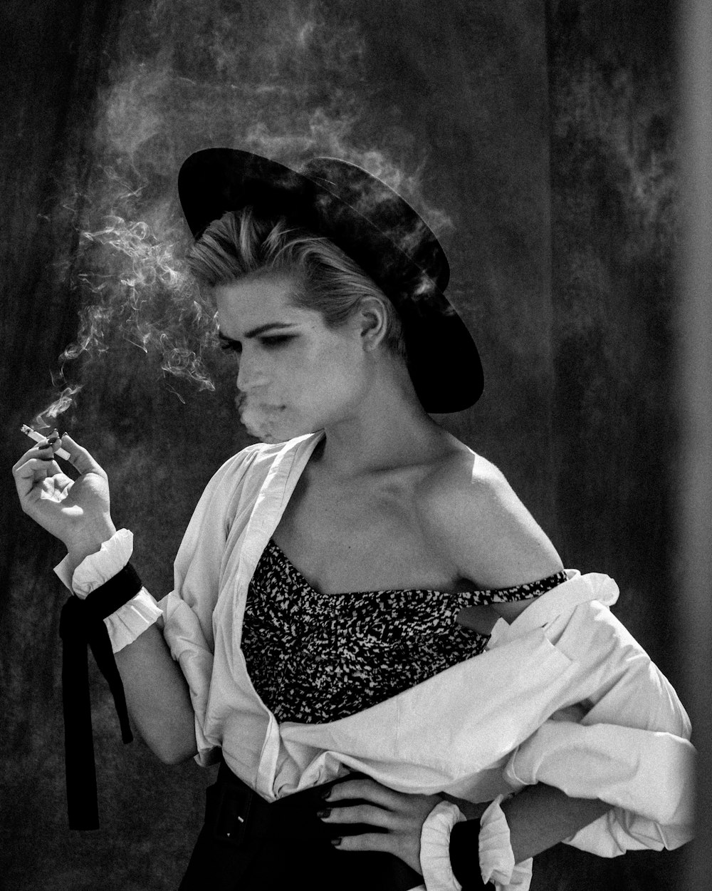 grayscale photography of woman smoking cigarette