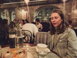 Photo of Demi Ding and Jessie Qiu collaborating with a restaurant owner in a cozy, modern eatery.