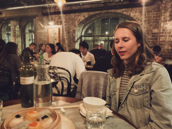 Photo of Demi Ding and Jessie Qiu collaborating with a restaurant owner in a cozy, modern eatery.