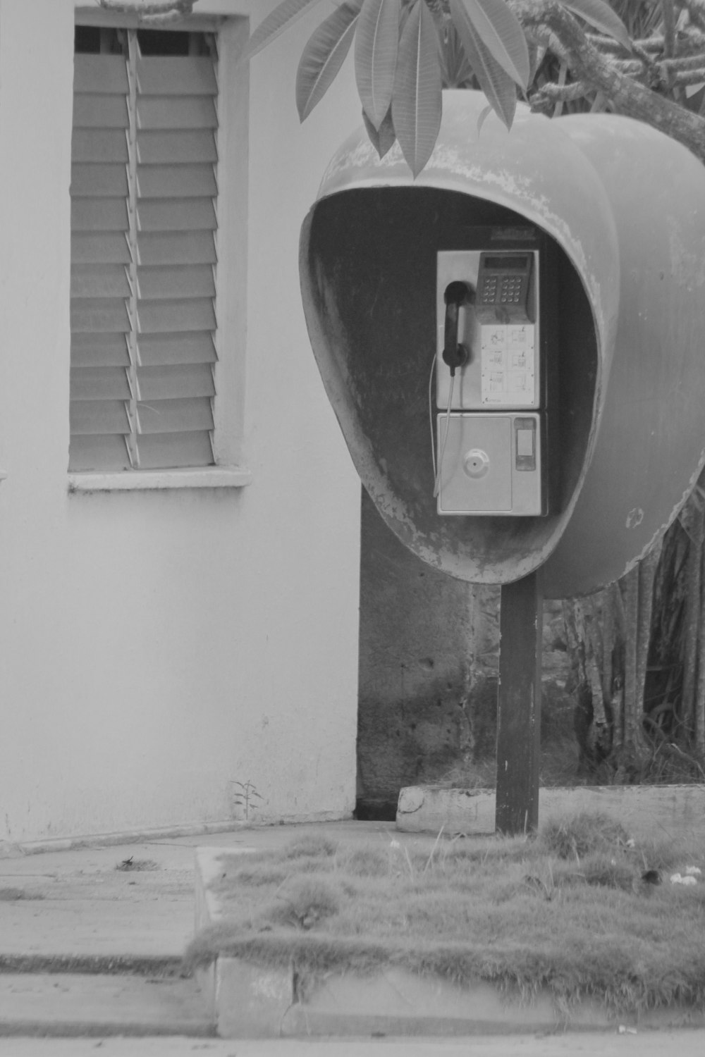 gray scale photo of telephone booth