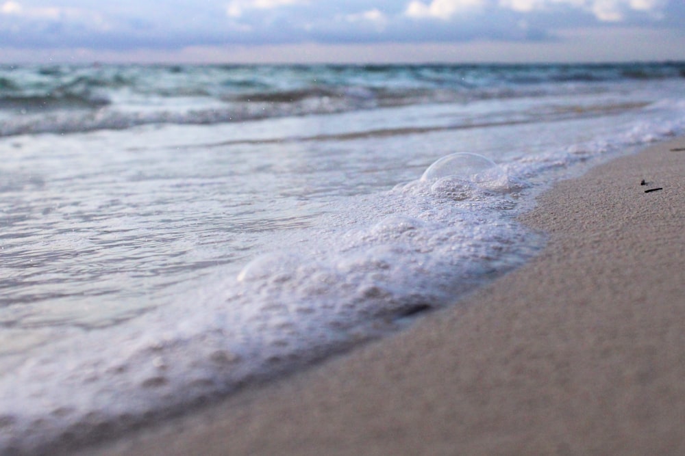 a close up of a wave on a beach