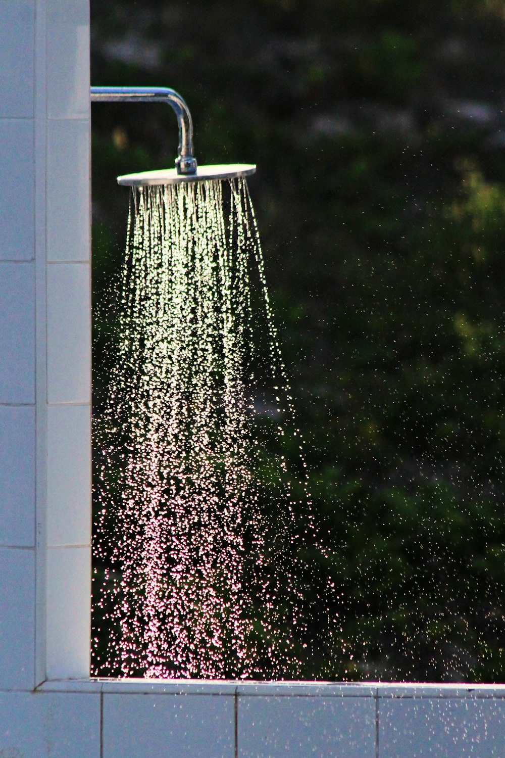 A shower head releasing water.