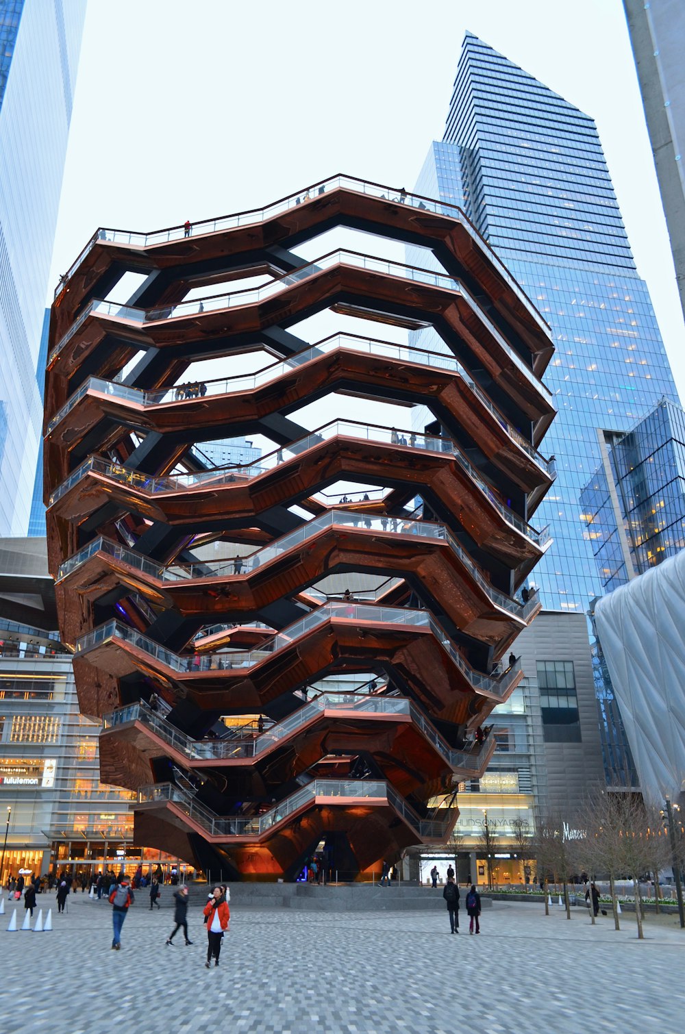 people walking near vase form structure