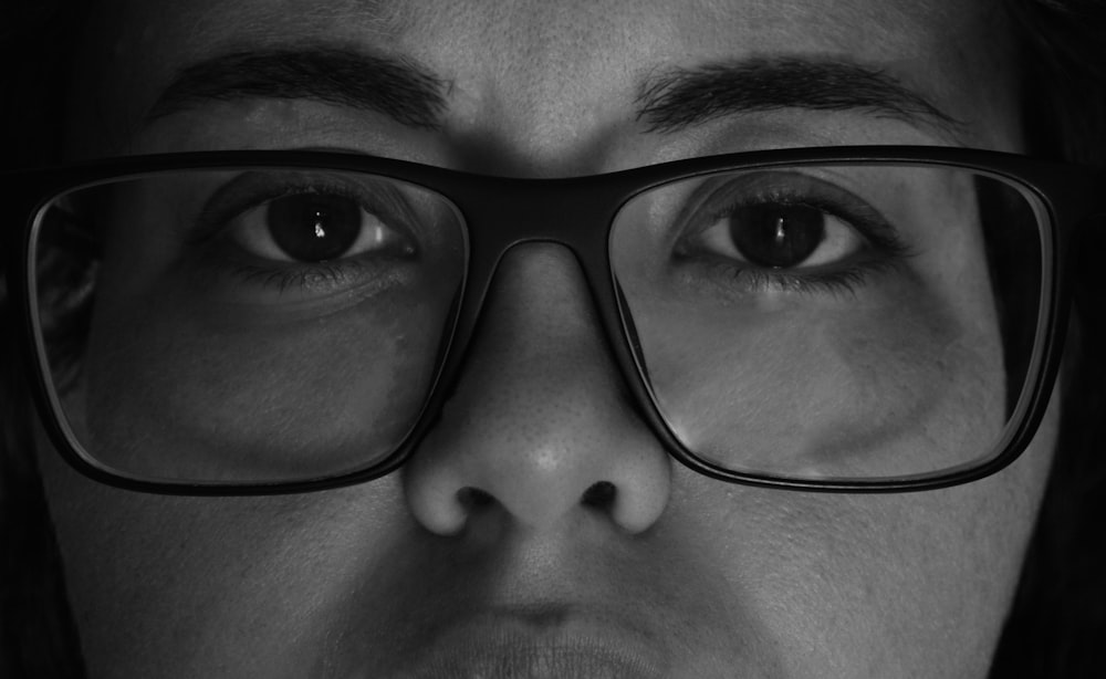 grayscale photo of woman wearing eyeglasses