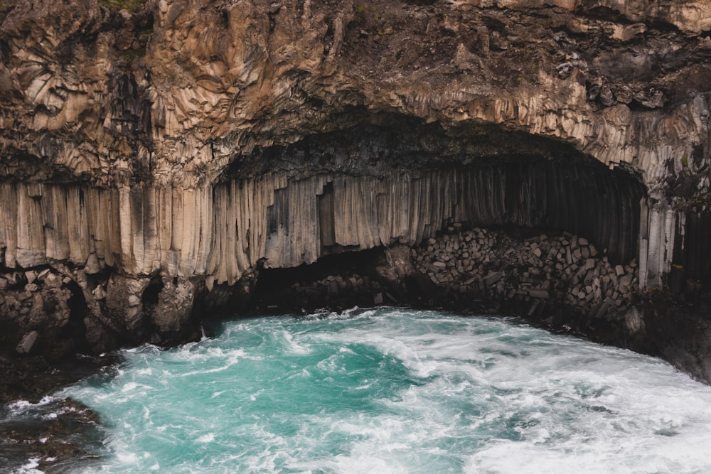 a cave with a body of water inside of it