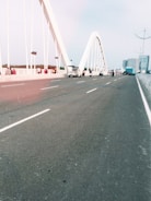 A modern bridge spanning a river with vehicles crossing.