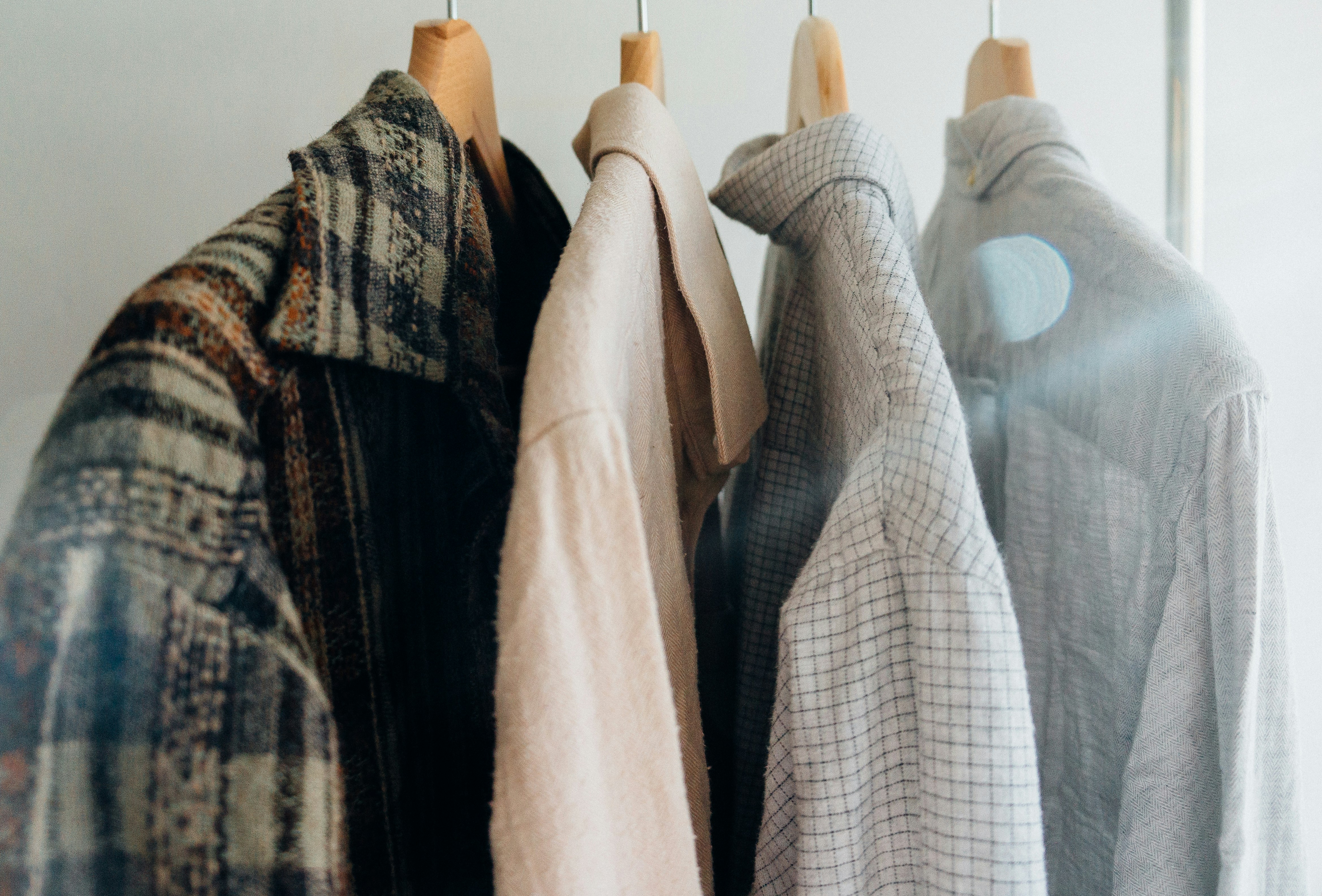 Shirts and Jacket hanging on rail.