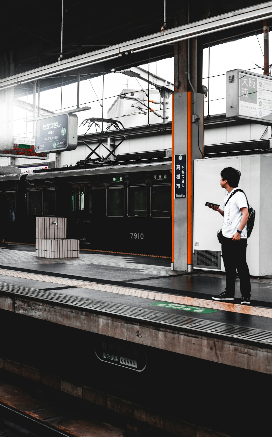 man standing on a train station