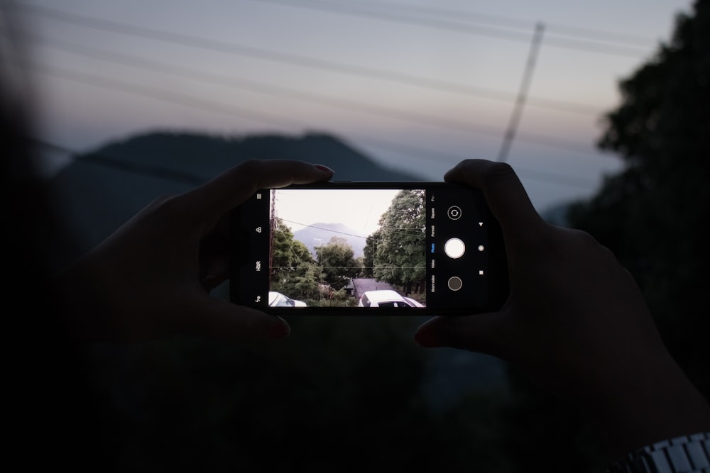 person holding black smartphone